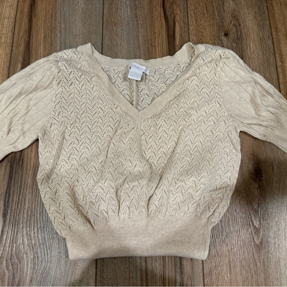 two cream knit tops